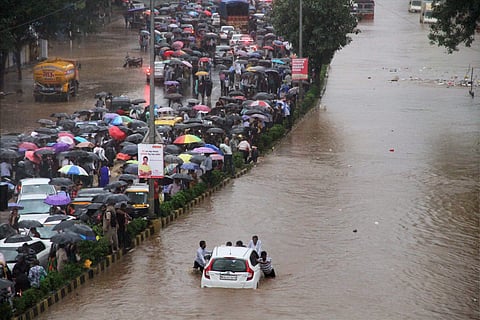 Vehicles stuck at a flooded street after heavy rains in Thane Mumbai on Tuesday. | PTI