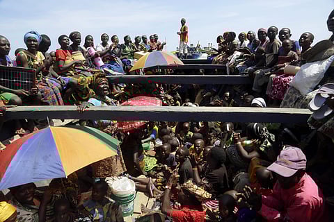 FILE - In this Saturday, May 23, 2015 file photo, refugees who fled Burundi's violence and political tension sing in a speedboat taking them to a ship freighted by the UN, at Kagunga on Lake Tanganyika, Tanzania. Hundreds of people have been killed and hu