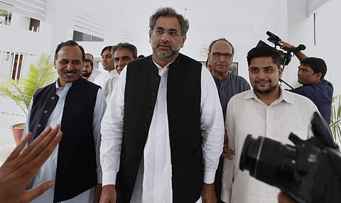 Shahid Khaqan Abbasi (c) is likely to continue as premier for the remaining 10-month tenure (File | AP)