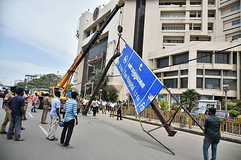 The Hoarding which fell on Anna Salai  is being removed using a crane. The hoarding fell on the road when the pillar supporting it was rammed by a MTC bus in Chennai. (P Jawahar | EPS)