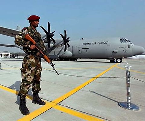 A Special Forces commando stands guard near the C-130J-30 Super Hercules aircraft at a ceremony at the Air Force Station at Hindon near New Delhi. AP