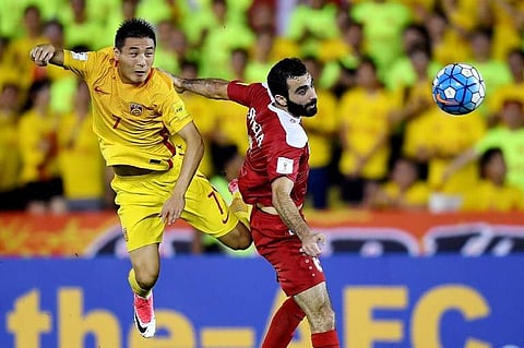 China striker Wu Lei (L) | AFP