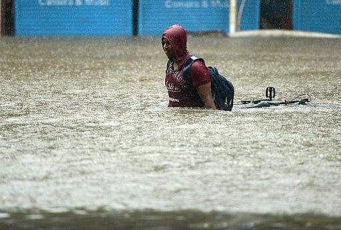 Heavy rainfall in Mumbai has disrupted life. Local trains have been halted, cars are stuck on roads and airport operations were suspended. (Photo | AFP)