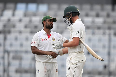 Bangladesh's Tamim Iqbal, left, shakes hand with Australia's Pat Cummins after the match (AP)