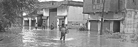 File photo of residents wading through flood water in Dandiapali area on outskirts of Rourkela | Express