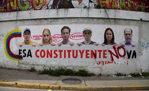A poster that shows some of Venezuela's opposition leaders holding a sign with a message that reads in Spanish: 'That constituent assembly will not pass' is displayed on a wall near Altamira Square in Caracas, Venezuela, Thursday, Aug. 3, 2017. (Photo | A