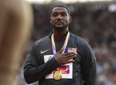 United States' gold medal winner Justin Gatlin listens to the national anthem during the medal ceremony for the men's 100-meter final at the World Athletics Championships in London. | AP