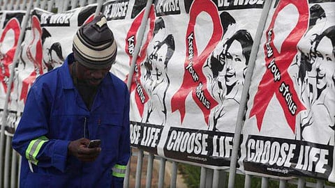 A man walks by World AIDS Day banners in, in this file photo from Dec. 1. (Associated Press)