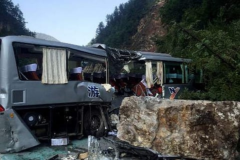 At least 12 people were killed when a 6.5-magnitude earthquake struck southwestern China on Tuesday. A tour bus damaged during an earthquake is seen in Jiuzhaigou. (AFP)