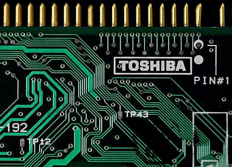 A logo of Toshiba Corp is seen on a printed circuit board in this photo illustration taken in Tokyo. (Photo | Reuters)