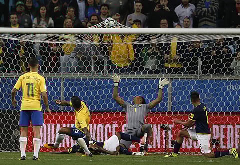 Brazil's Pualinho strikes to score as Ecuador Goalkeeper Maximo Banguera fails to stop it during a World Cup qualifying fixture in Brazil (AP)