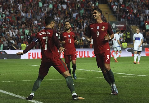 Portugal's Cristiano Ronaldo celebrates after scoring his side's second goal during the World Cup qualifying against Faroe Islands (AP)