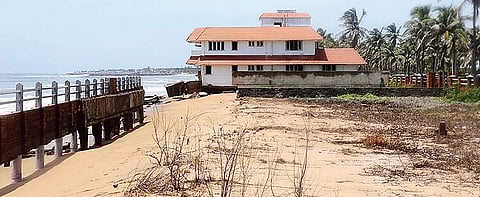 A JCB clearing the building debris of a bungalow, which was overrun by tides at Muttukadu | shiba prasad sahu