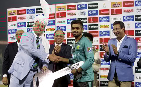 Pakistani cricketer Babar Azam, center, receives man of the match award from Director of the International Cricket Council (ICC) Giles Clarke at the end of the first Twenty20 match against World XI. | AP