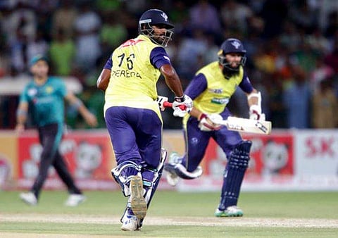 World XI batsman Hashim Amla, right, runs between the wickets with his partner Thisara Perera during the second Twenty20 match at the Gaddafi Cricket Stadium in Lahore, Pakistan on Sept. 13, 2017. (Photo | AP)