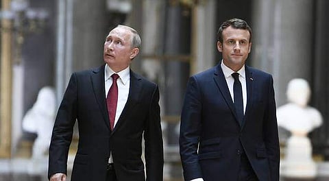 Emmanuel Macron and Vladimir Putin walk at the Versailles Palace, near Paris | AP