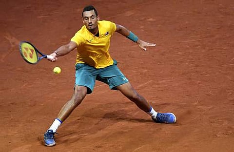 Australia's Nick Kyrgios reaches out to return the ball to Belgium's Steve Darcis during a Davis Cup World Group semi-final tennis match in Brussels. | AP