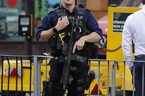 An armed police officer stands nearby after an incident on a tube train at Parsons Green subway station in London on Sept. 15, 2017. (Photo | AP)
