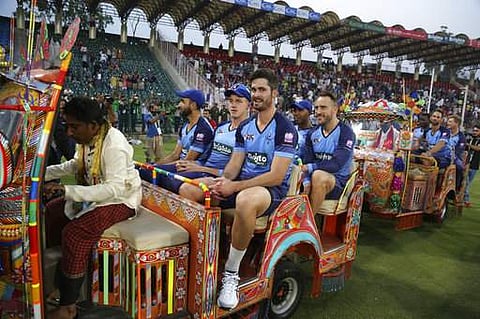 Members of the World XI team ride in traditional rickshaws before the start of the first Twenty20 cricket match between the World XI team and Pakistan, in Lahore, Pakistan. | AP