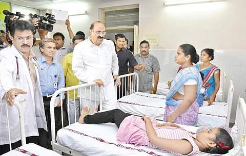 Health Minister Kamineni Srinivas enquiring about the health condition of kids  at SVR Ruia Hospital in Tirupati on Friday | Express