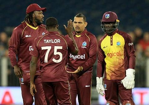 West Indies' Sunil Narine (C) celebrates taking the wicket of England's David Willey during the T20 International cricket match between England and West Indies at The Emirates Riverside. | AFP