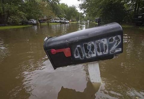 A partially submerged mailbox stands in Bacliff, Texas on Saturday, Aug. 26, 2017. The fiercest hurricane to hit the U.S. in more than a decade came ashore late Friday about 30 miles (48 kilometers) northeast of Corpus Christi as a mammoth Category 4 stor