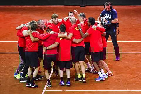 Belgium's Davis Cup team players and staff celebrate after winning the Davis Cup World Group semi-final tennis match against Australia in Brussels. | AP