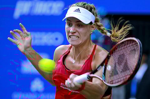 Angelique Kerber of Germany returns a shot to Naomi Osaka of Japan during their first round match of the Pan Pacific Open tennis tournament in Tokyo (AP)