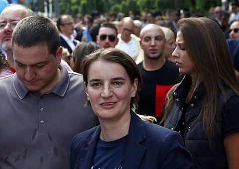 Serbia's Prime Minister, Ana Brnabic, center, attends a gay pride march in Belgrade, Serbia, Sunday, Sept. 17, 2017. Serbia's first ever openly gay prime minister joined several hundred gay activists Sunday at a pride event in Belgrade amid tight security