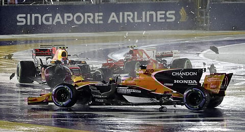 The car's of McLaren driver Fernando Alonso of Spain, Red Bull driver Max Verstappen of the Netherlands and Ferrari driver Kimi Raikkonen of Finland after colliding at the start of the Singapore Formula One Grand Prix. | AP