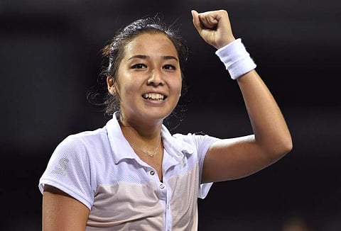 Zarina Diyas of Kazakhstan gestures as she celebrates her win over Japan's Miyu Kato in their women's singles final at the Japan Women's Open tennis tournament in Tokyo. | AFP
