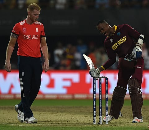 England's Ben Stokes looks on as West Indies's Marlon Samuels gestures after victory in the World T20 cricket tournament final match between England and West Indies. | AFP