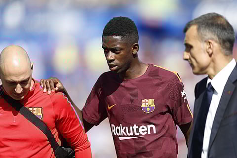 Barcelona's Ousmane Dembele leaves the pitch injured during La Liga match against Getafe. | AP