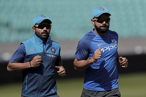 Captain Virat Kohli (R) might consider giving Ajinkya Rahane,  who is yet to get a chance in the ongoing tournamnet when India face Sri Lanka tomorrow (File | AP)