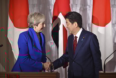 British Prime Minister Theresa May, left, and Japan's Prime Minister Shinzo Abe, right, shake hands during a joint press conference at the state guest house in Tokyo Thursday Aug. 31, 2017. | AP