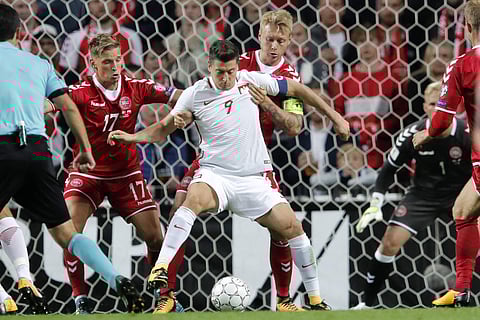 Poland's Robert Lewandowski (in white) couldn't rescue his team from the embarrassment at the Danish capital (AP)