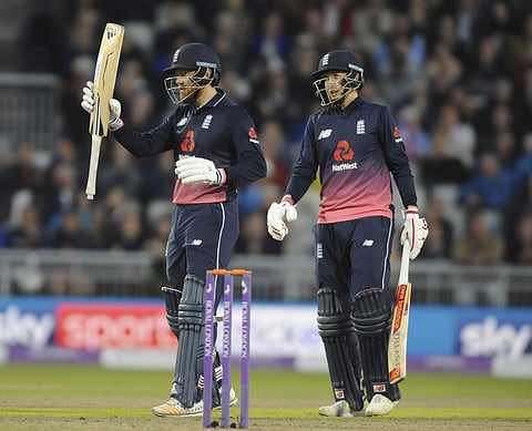 England's Johnny Bairstow, left, celebrates half century during the first One Day International match between England and West Indies at Old Trafford in Manchester. | AP
