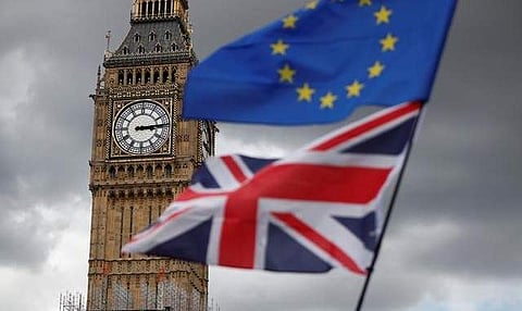 The Union Flag and a European Union flag fly near the Elizabeth Tower, housing the Big Ben bell, in Parliament Square in central London, Britain. (File photo | Reuters)