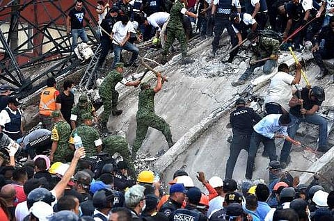 Rescuers search for survivors amid the rubble of a collapsed building after a powerful quake in Mexico City on September 19, 2017. (Photo | AFP)