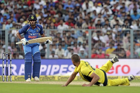 India's Hardik Pandya watches as Australia's Nathan Coulter-Nile tries to stop the ball during their second ODI at Eden Gardens (AP)
