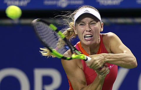 Caroline Wozniacki of Denmark returns a shot to Shelby Rogers of the United States (AP)