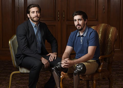 In this Sept. 10, 2017 photo, Jake Gyllenhaal, left, poses for portrait with Boston Marathon bombing survivor Jeff Bauman during the Toronto International Film Festival in Toronto. | AP