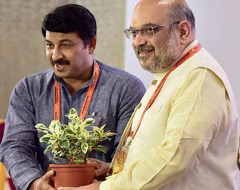 BJP National President Amit Shah being greeted by Delhi BJP chief Manoj Tiwari during the party office bearers' meeting at NDMC Convention Centre in New Delhi on Sunday. | PTI