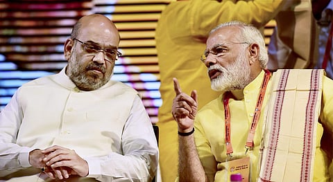 PM Narendra Modi and BJP chief at the national executive meet in New Delhi on Monday. (PTI)