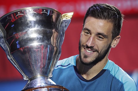 Damir Dzumhur of Bosnia and Herzegovina holds his trophy after winning the the St. Petersburg Open ATP tennis tournament final match against Fabio Fognini of Italy in St.Petersburg, Russia. (AP)