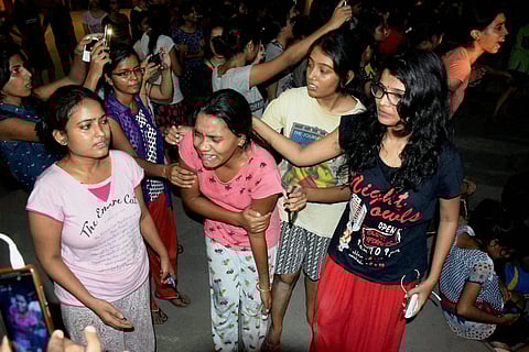An injured student writhing in pain after police allegedly beat them up during a clash at Banaras Hindu University late Saturday night. | PTI