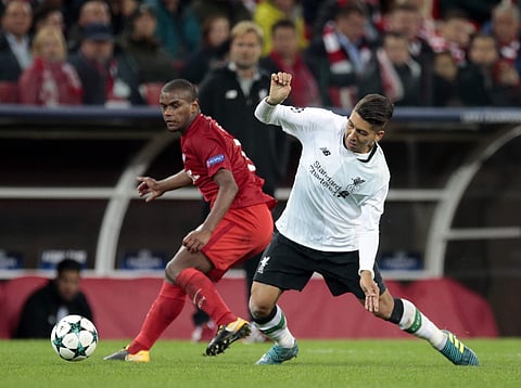 Spartak's Fernando, left, challenges for the ball with Liverpool's Roberto Firmino during the Champions League soccer match between Spartak Moscow and Liverpool in Moscow, Russia. (AP)