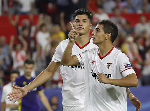 Sevilla's Wissam Ben Yedder, right, celebrates after scoring his side third goal, with his teammate Joaquin Correaduring the Cha mpions League Group E soccer match between Sevilla and Maribor at the stadium Ramón Sánchez Pizjuán in Seville, Spain. (AP)