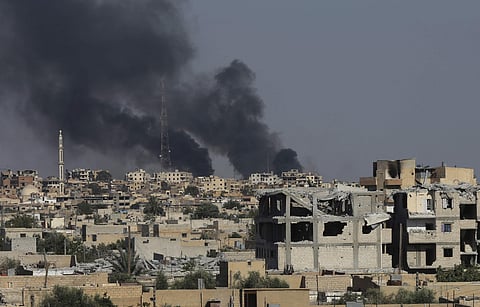 Black smoke rises from Raqa city where U.S.-backed Syrian Democratic Forces fighters battle against the Islamic State militants, in Raqqa. (AP Photo/Hussein Malla)