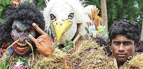 Devotees dressed as gods at the annual Ezhai Katha Amman Temple festival at Vellalur near Melur in Madurai district, on Tuesday | k k sundar